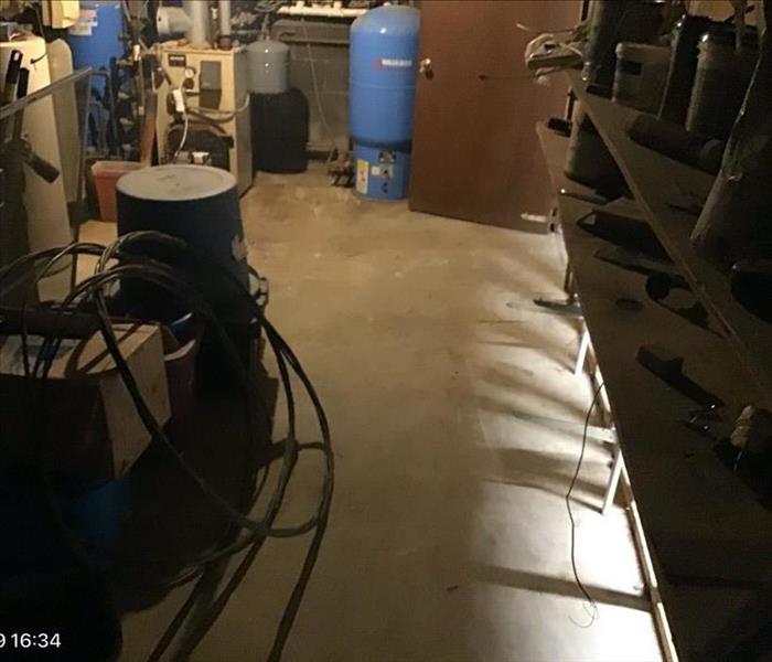 Basement with furnace and hot water heater with a dry floor