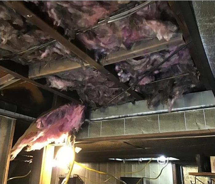 fire damaged open ceiling, soot, and insulation